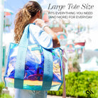 Person holding a large, colorful tote bag with text about its size and functionality.