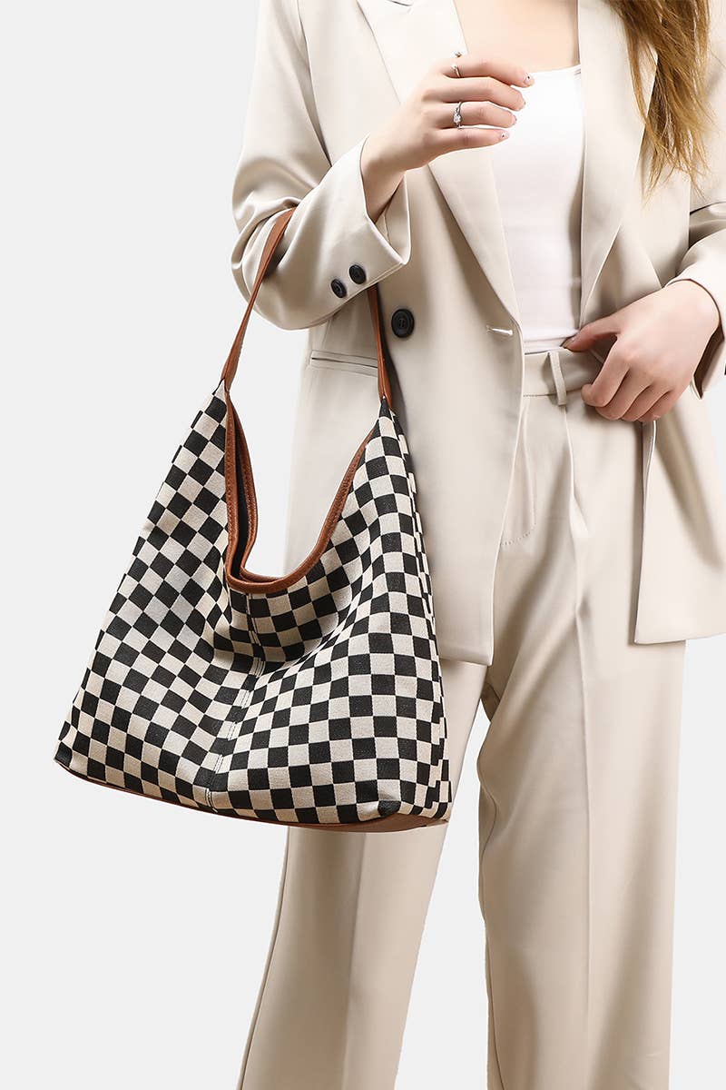 Person wearing a beige suit with a checkered handbag on a white background