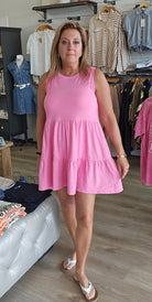 Woman wearing a pink dress in a clothing store