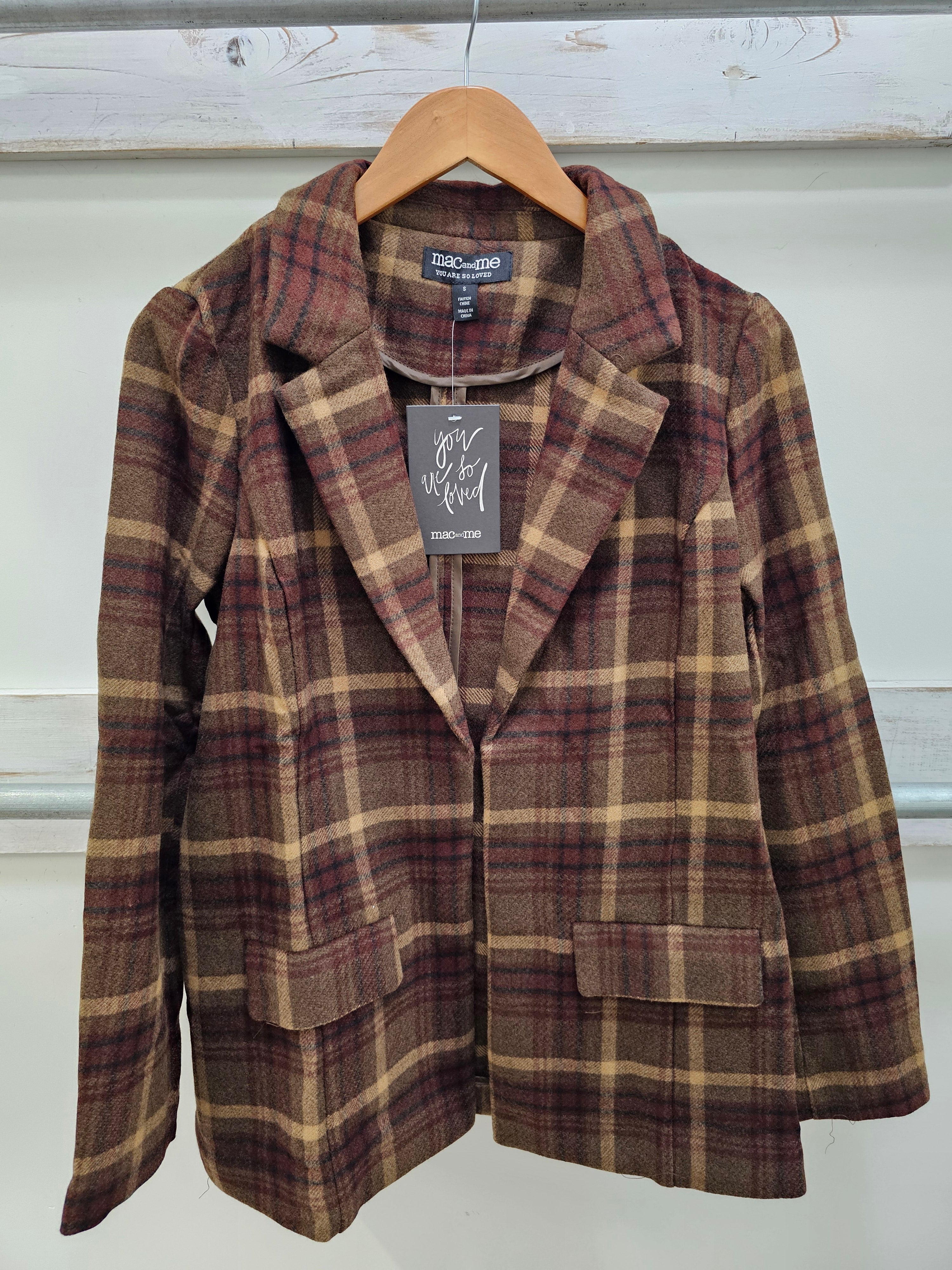 A women's plaid blazer jacket from the brand Chloé, hanging on a wooden hanger against a white paneled wall. The jacket features a brown, beige, and burgundy tartan pattern with notched lapels and front flap pockets.