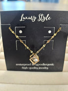 A gold chain necklace with a geometric pendant displayed on a black card labeled 'Luxury Style'.